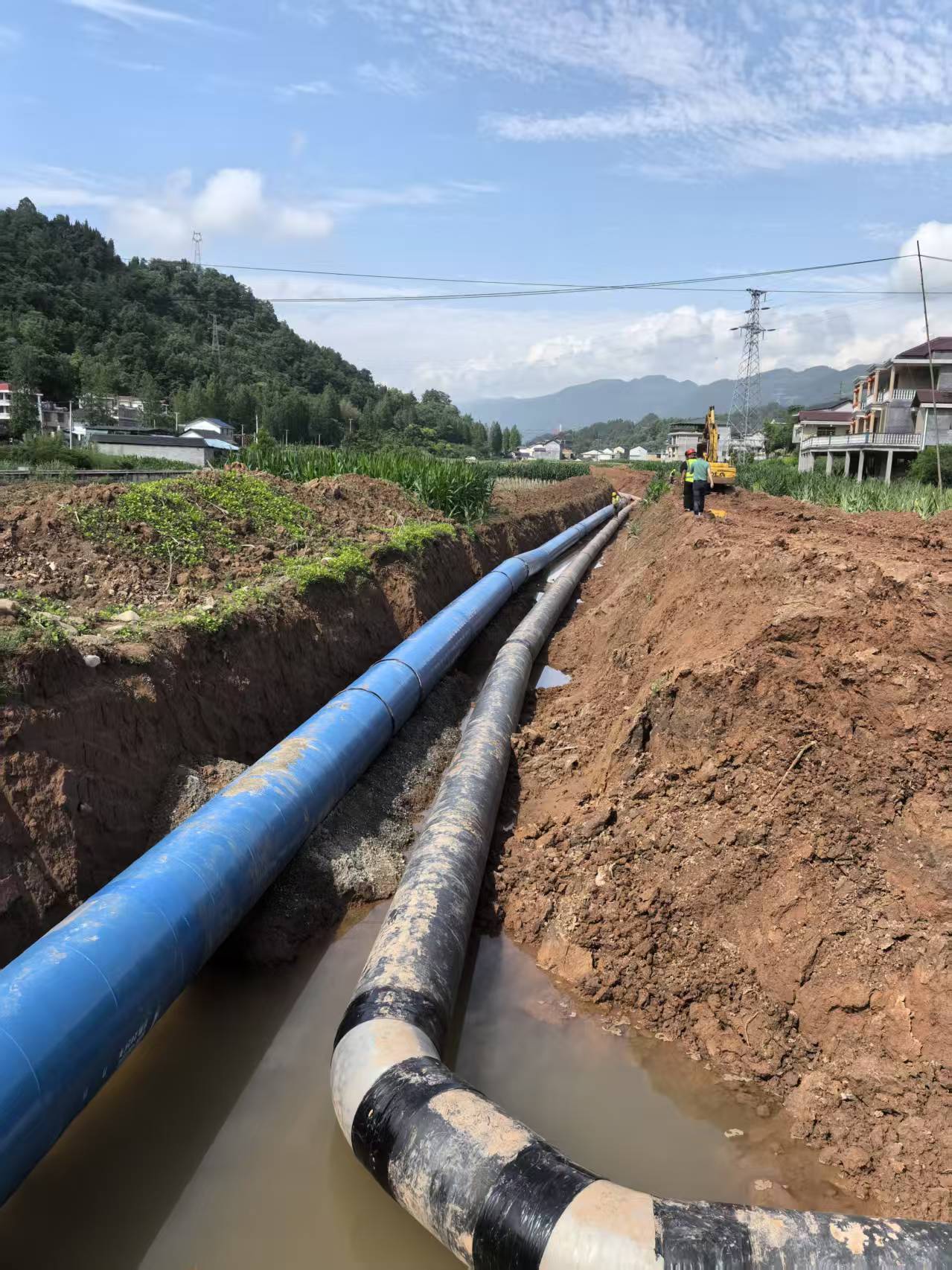 Two parallel pipelines installed in an open trench for municipal water or district energy distribution